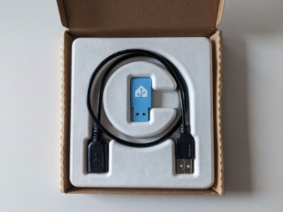 Image showing the Assistant Connect ZBT-1 with the USB extension cable in the original packaging