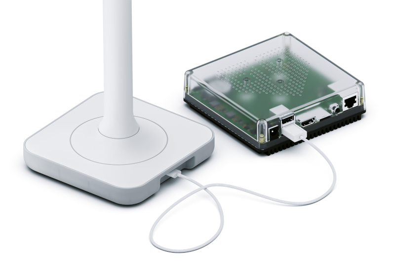 Image showing the Assistant Connect ZWA-2 with the USB cable and a Home Assistant Green